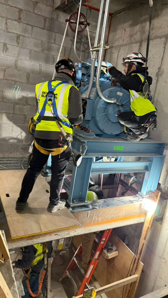 Skyline crew installing elevator